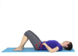 pelvic tilt where a woman in a purple tshirt lays on the floor on her back with knees bent, pushing her lower back to the floor. 